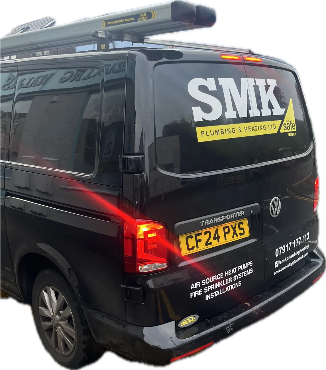 The black SMK Plumbing & Heating van, a VW Transporter with the yellow SMK stripe on the back window