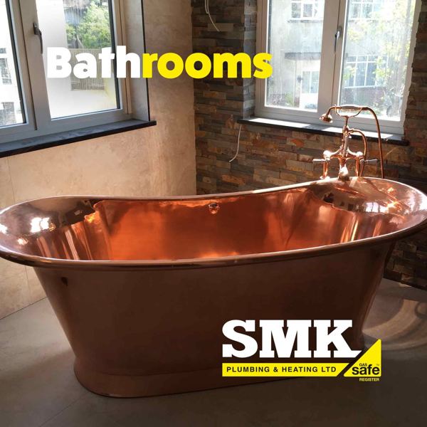 Freestanding copper bath with a copper mixer tap