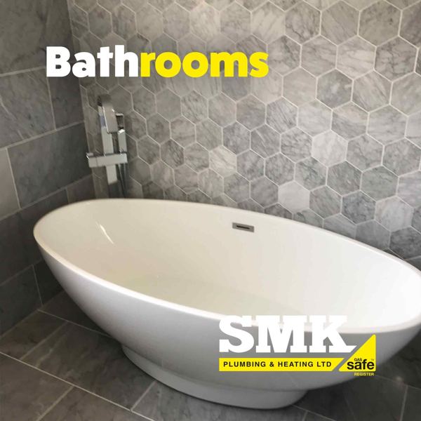 White freestanding bath against hexagon marble tiles