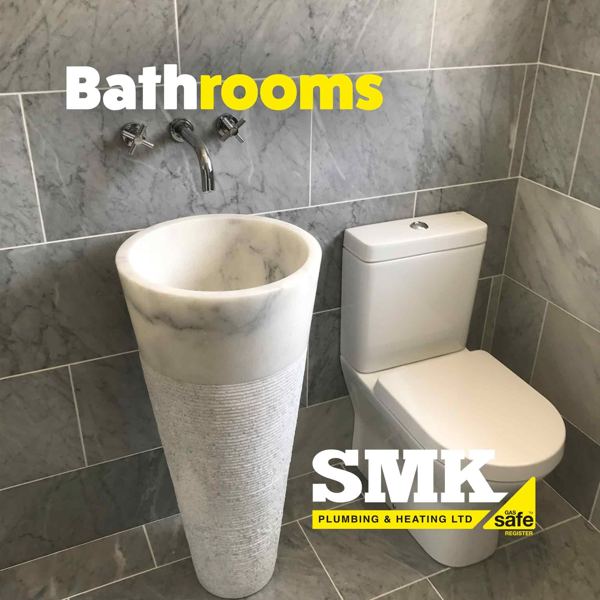 Stone pedestal basin and close-coupled toilet with a wall tap
