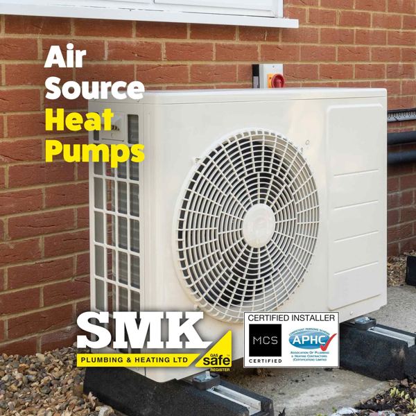 Air source heat pump fitted against a brick wall