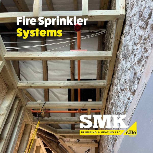 Sprinkler pipes run through a timber stud ceiling